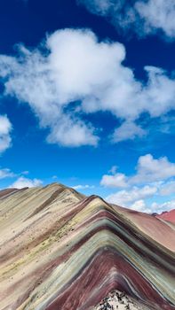 Vibrant layers of Rainbow Mountain under a clear blue sky in Peru.