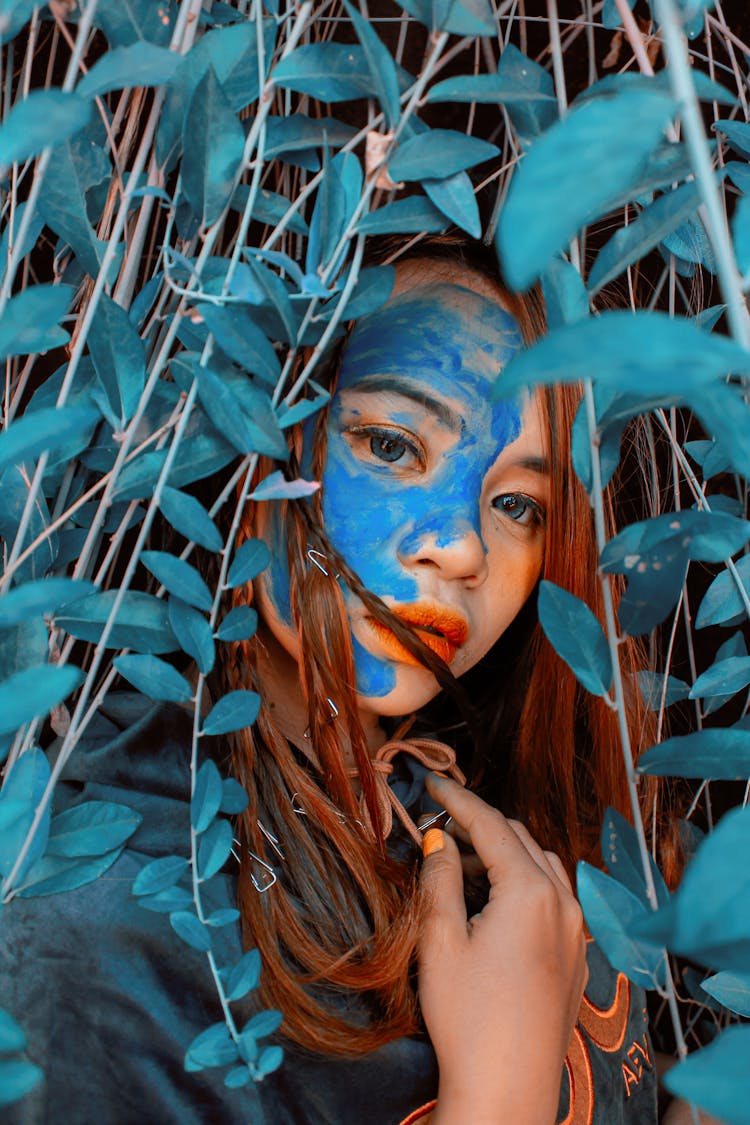 Woman Behind Blue Leaves