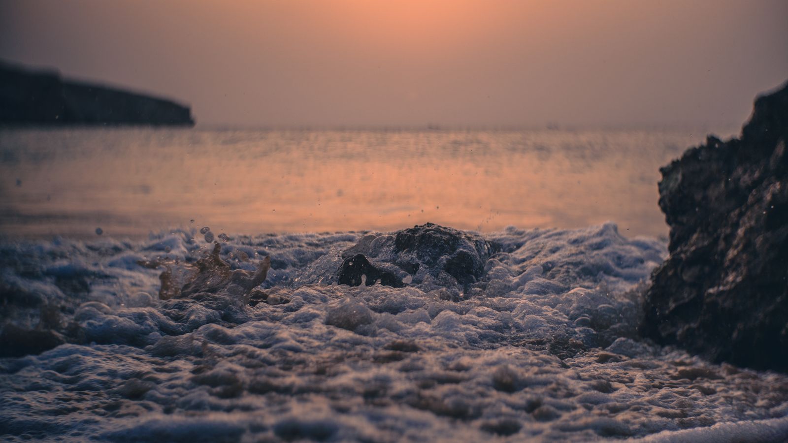 A sunset over the ocean with waves crashing, Djibouti