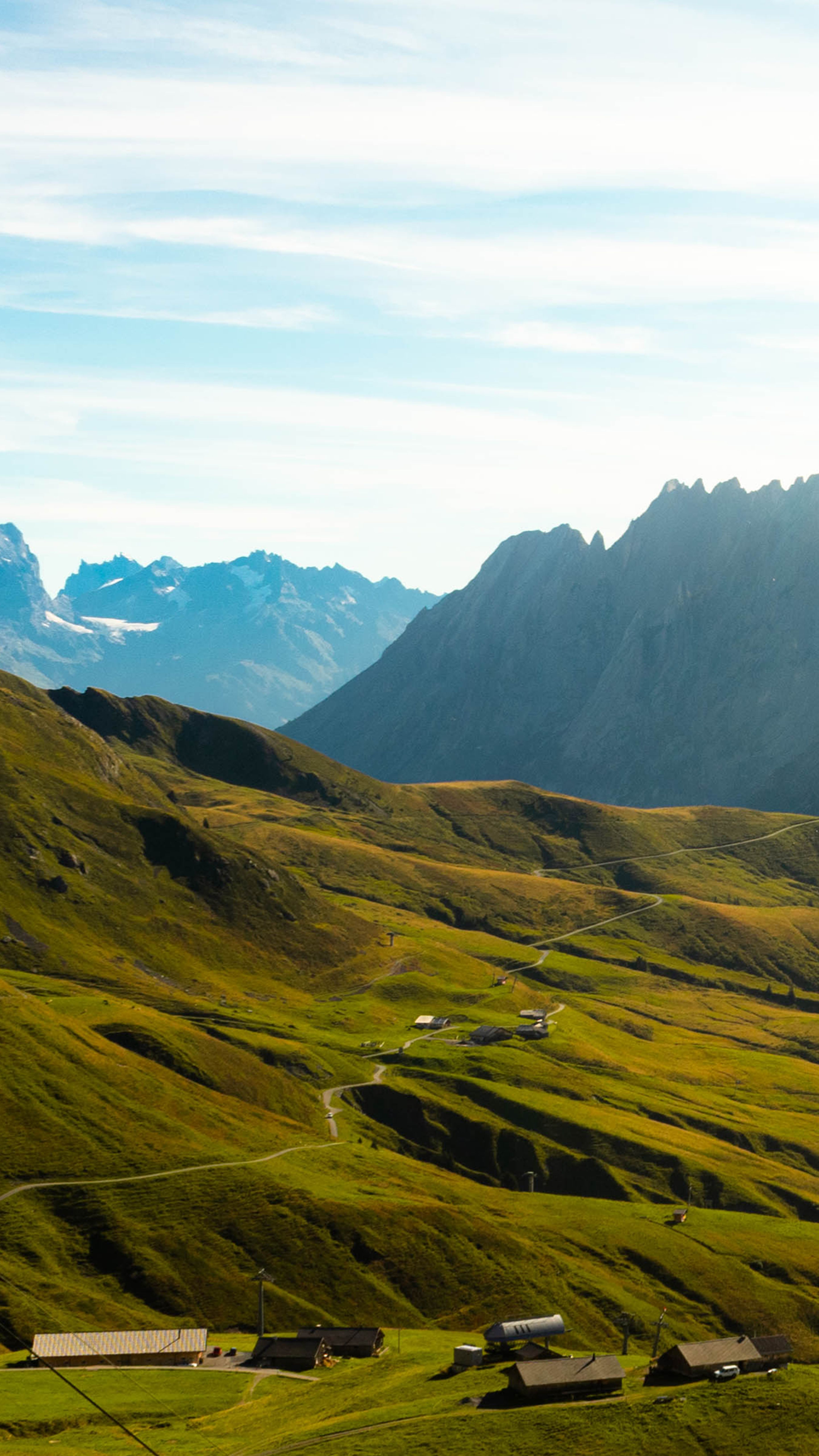 A scenic view of a valley with mountains in the background · Free