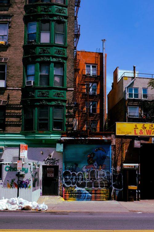 Free Vibrant urban street in SoHo, NYC featuring graffiti and classic architecture. Stock Photo
