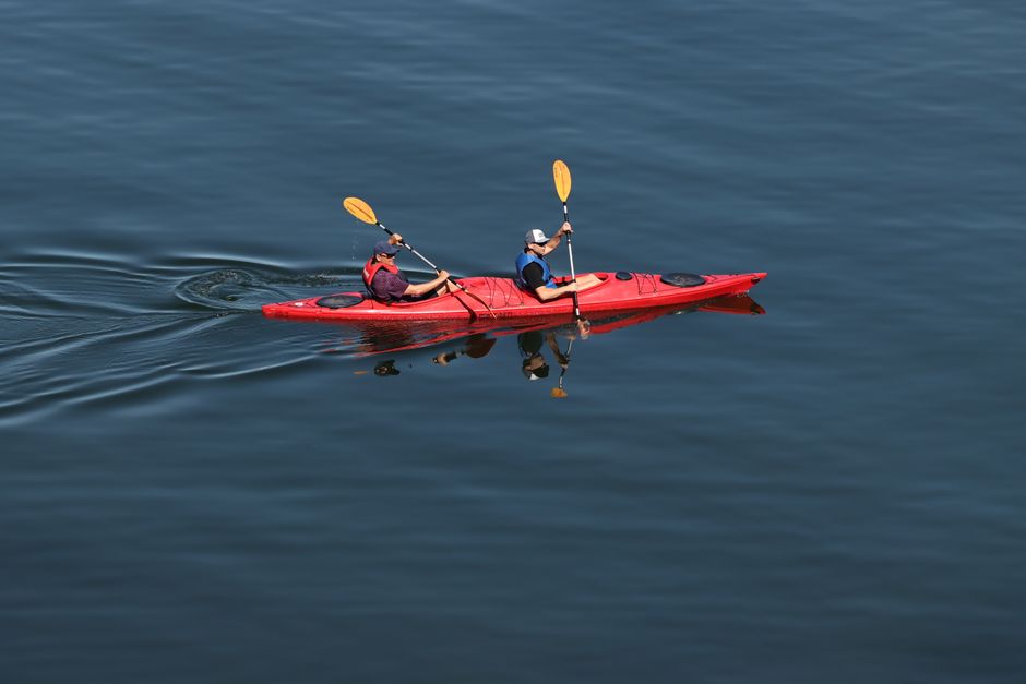Kayakers enjoying the lake near Trakai Castle in Lithuania, highlighting adventure sports