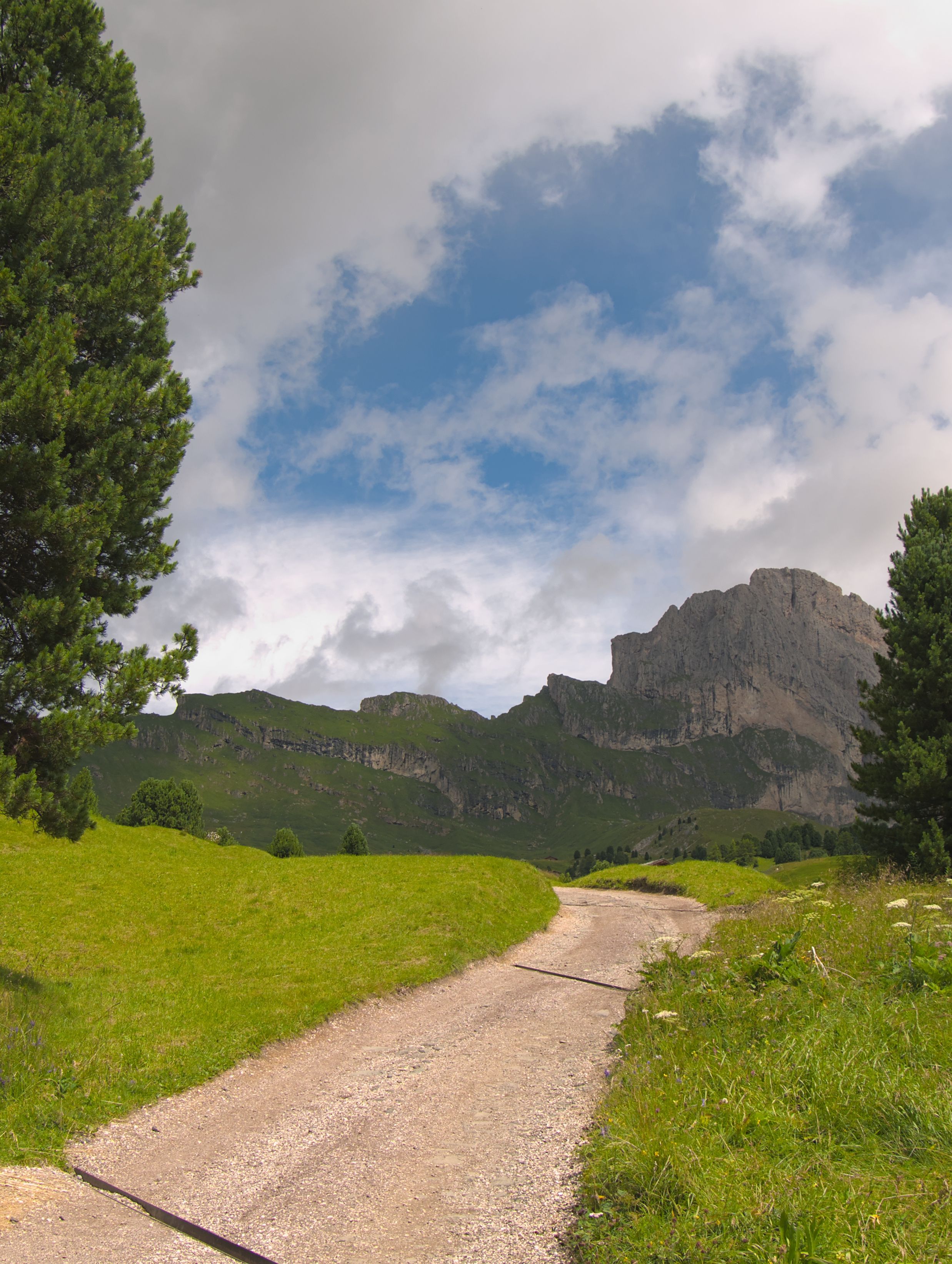 Dirt Road in the Countryside and a Rocky Mountain · Free Stock Photo