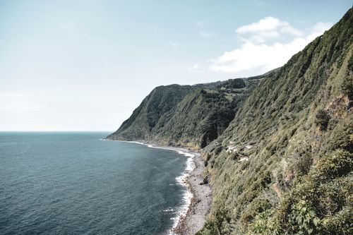 Free Breathtaking view of coastal cliffs against a vast ocean under a clear sky. Stock Photo