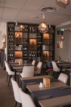 A sophisticated dining room featuring modern furniture and ambient lighting for a luxurious experience.