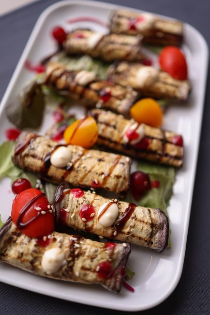 Salted, oiled eggplant rounds grilled until charred and tender, finished with lemon and herbs.