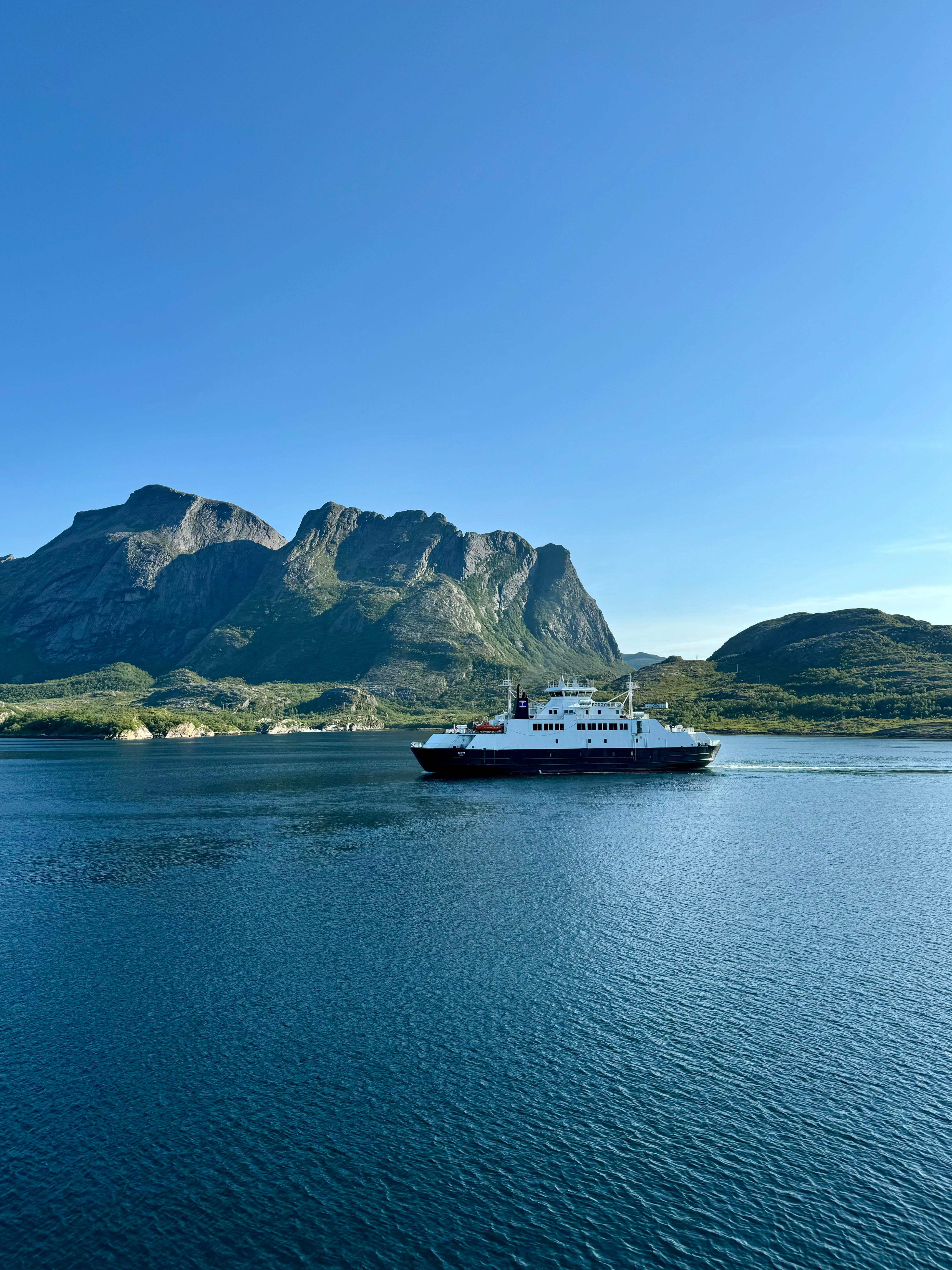 a boat is traveling through the water near mountains