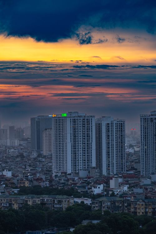 Free Stunning view of Hà Nội skyline at sunset with vibrant clouds and high-rise buildings. Stock Photo