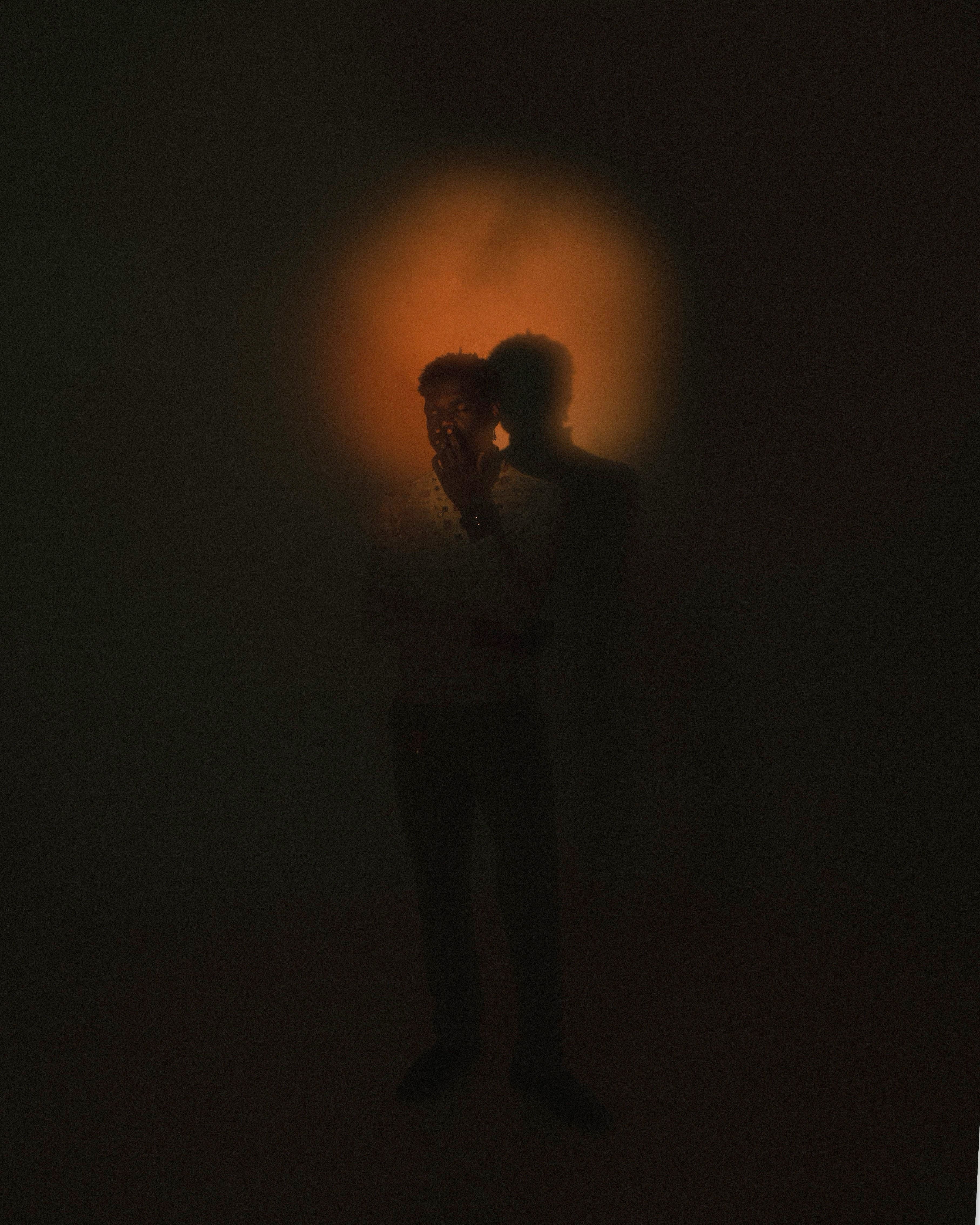 A silhouette of a person with a glowing aura, creating a mysterious and artistic effect.