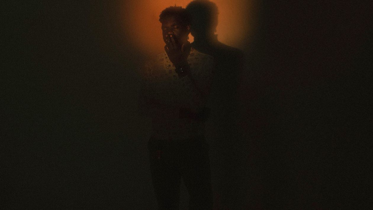 Profile silhouette against a glowing halo, suggesting supernatural powers.