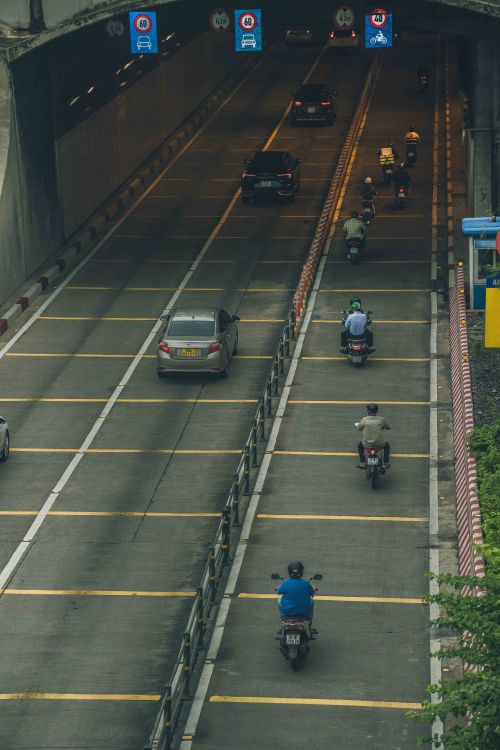 Free Motorcycles and cars in motion through a tunnel in Ho Chi Minh City, Vietnam. Stock Photo