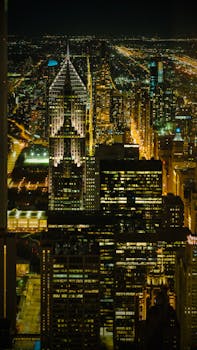 Stunning view of an illuminated city skyline showcasing towering skyscrapers under a night sky.