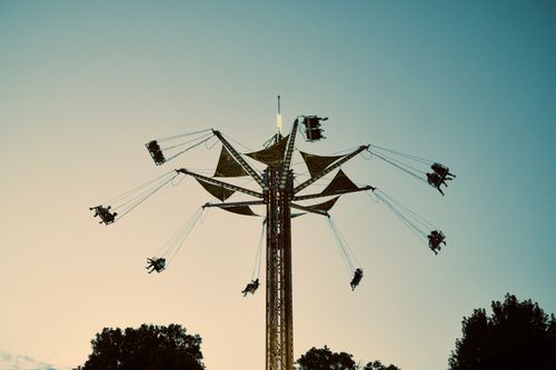Free Captivating swing ride silhouette against a summer sunset sky in Arlington Heights, IL. Stock Photo
