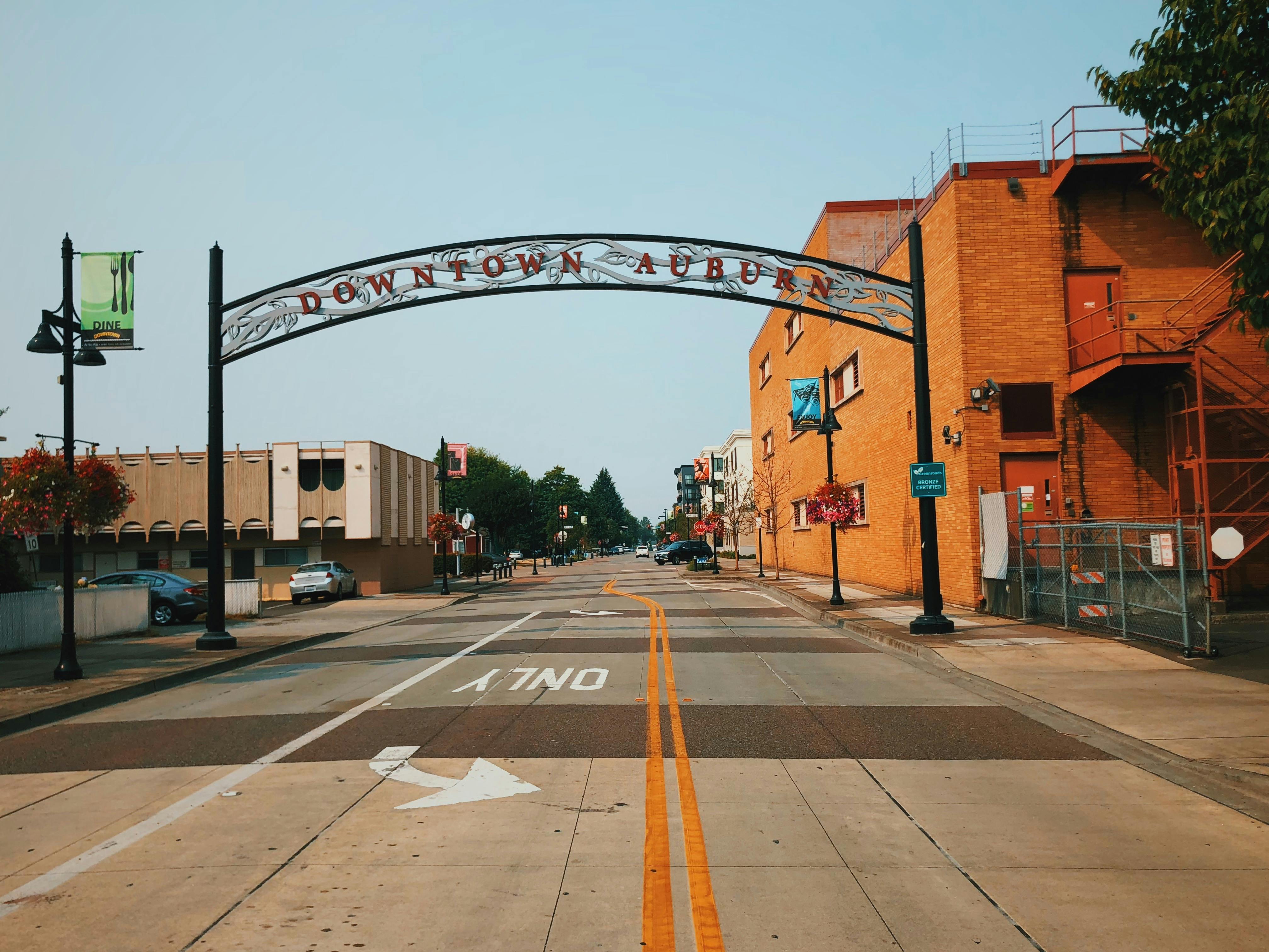 View of a street in downtown Auburn featuring an archway and urban architecture.
