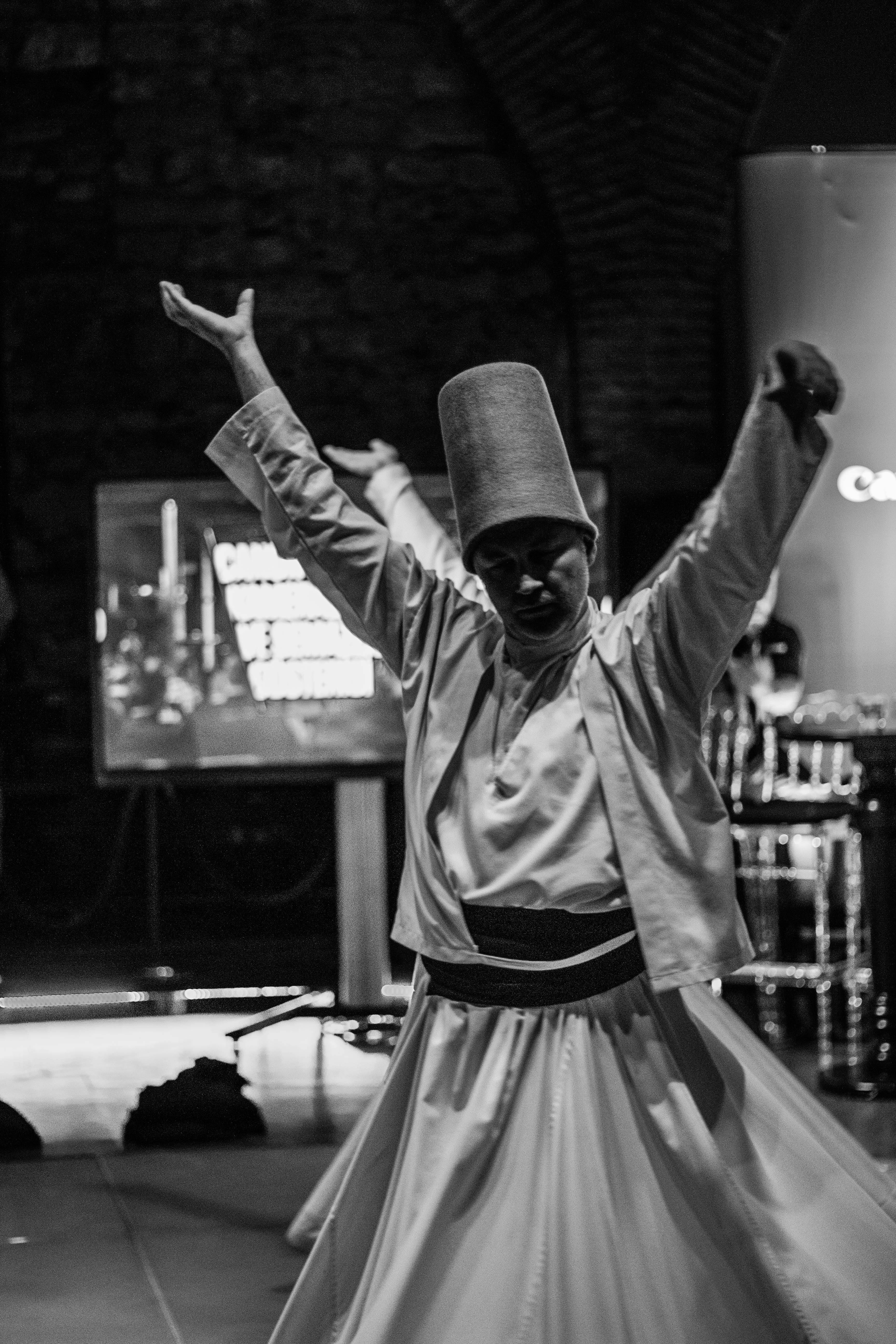 a man in a traditional turkish outfit dancing