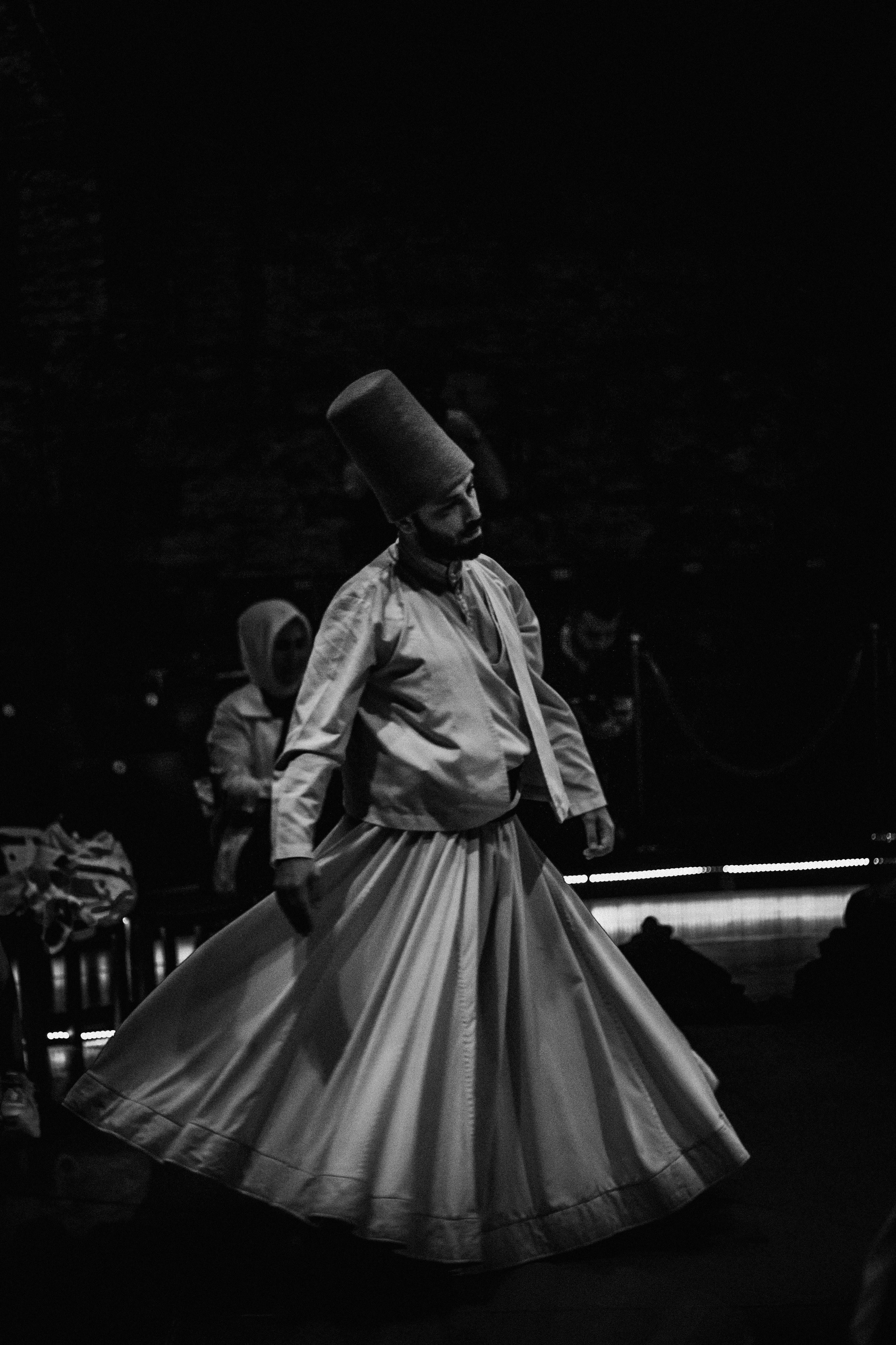 Black and white photo of a whirling dervish in Istanbul showcasing traditional sufi dance.