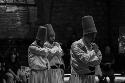 Free Traditional whirling dervish performers in Istanbul, Turkey captured in a dramatic black and white photograph. Stock Photo