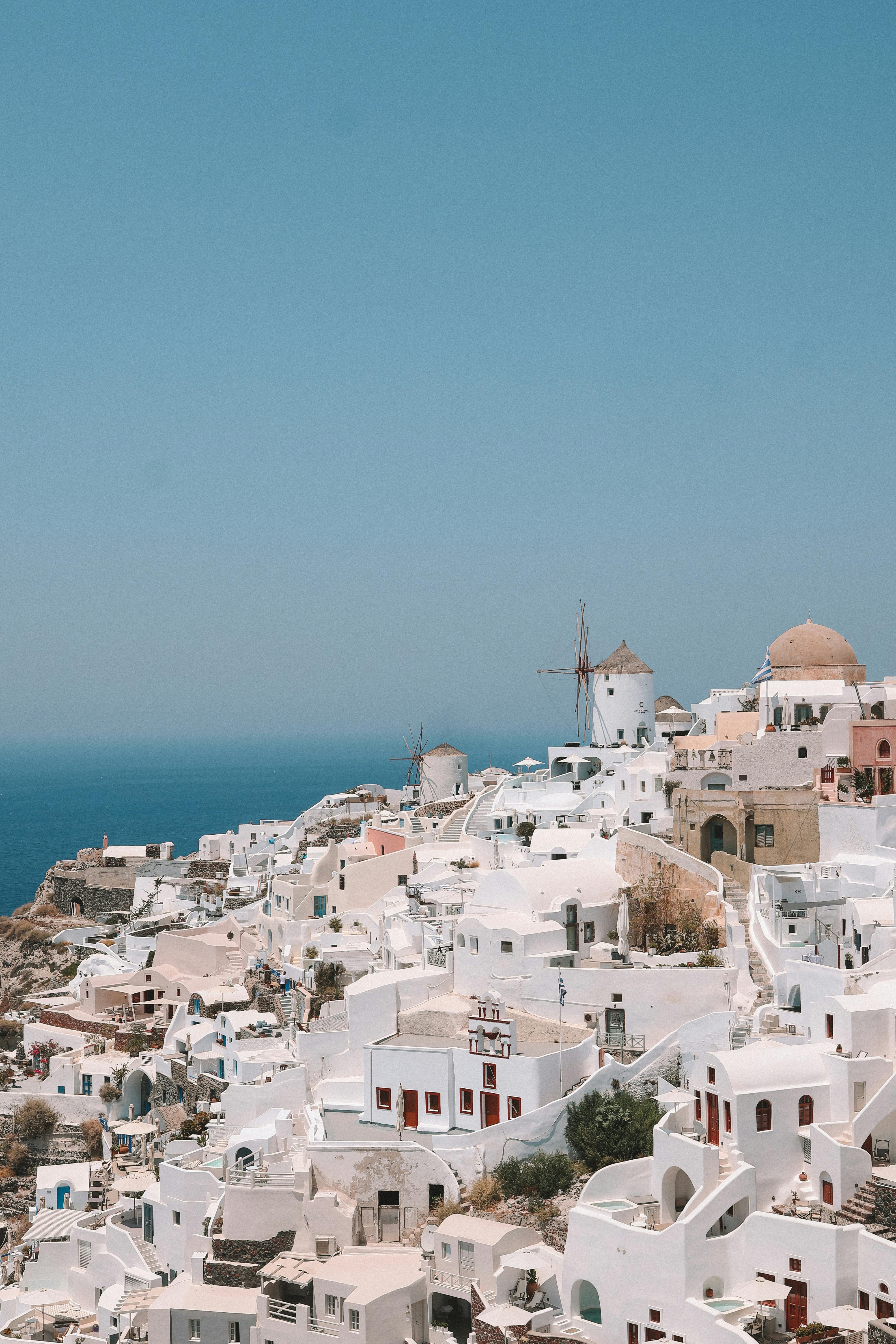 A breathtaking view of Santorini's iconic whitewashed buildings against the blue sea and sky.