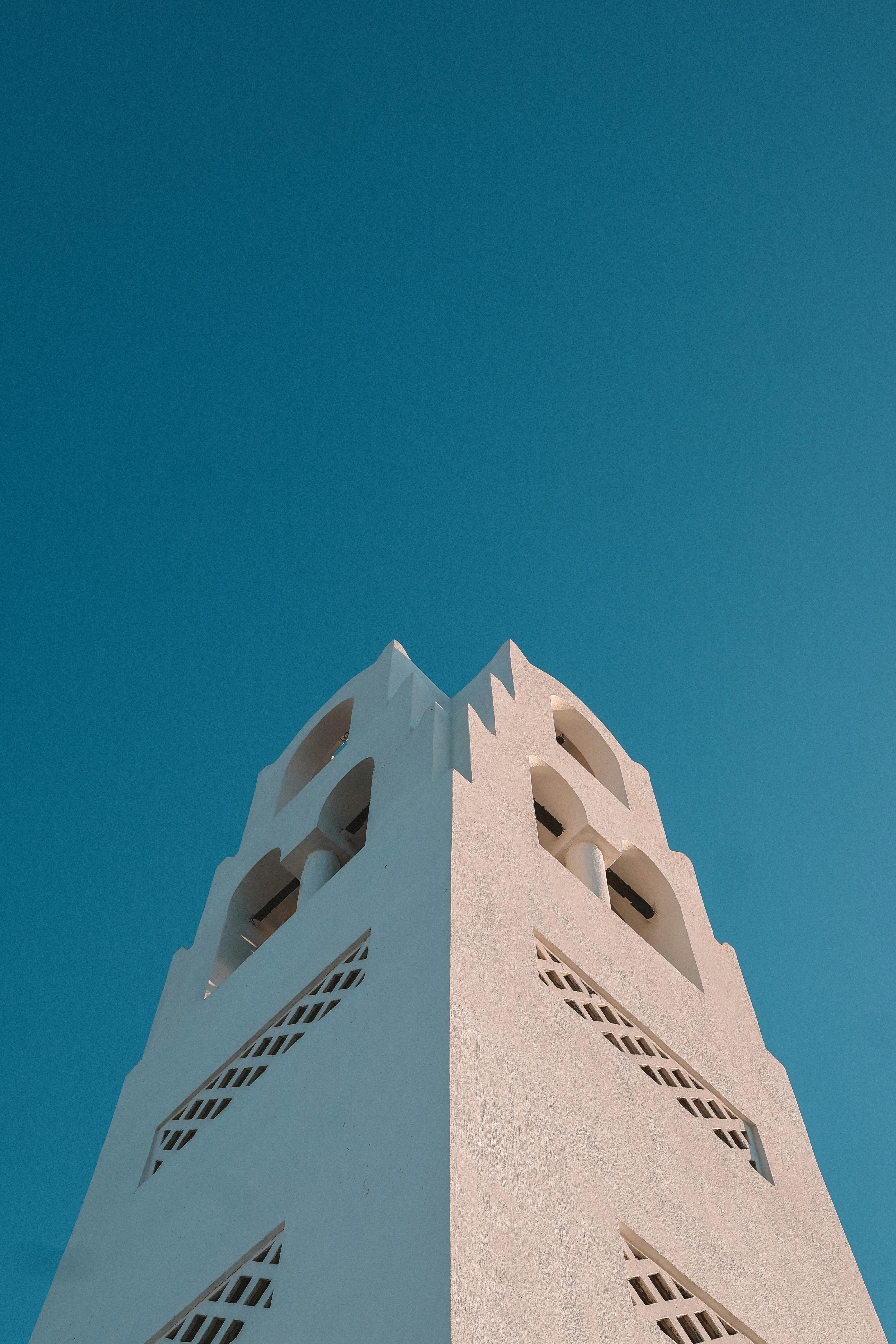 a white tower with a blue sky in the background