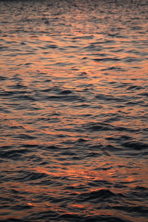 Free Serene golden sunset over the Aegean Sea in İzmir, capturing rippling reflections and tranquil vibes. Stock Photo