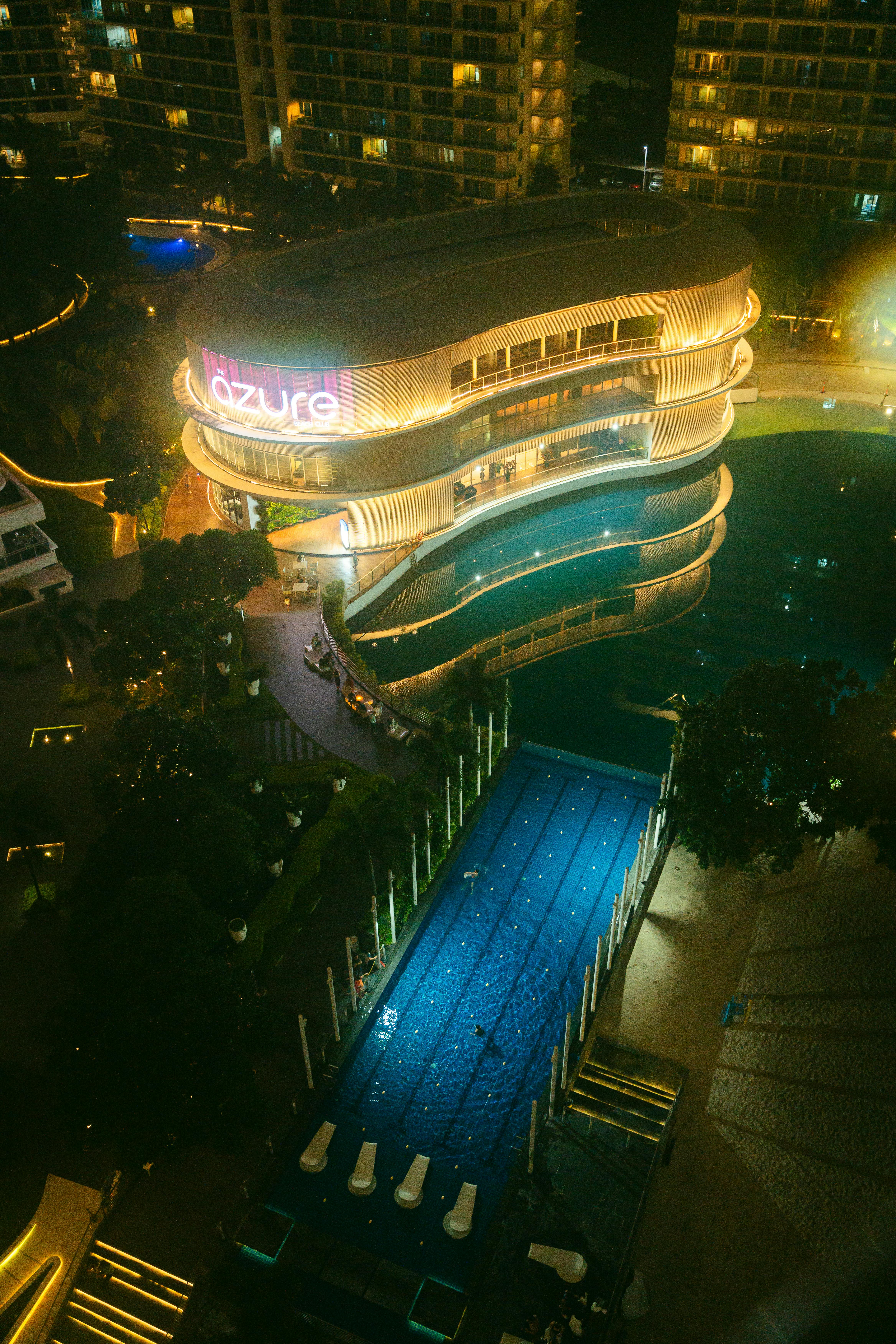 a view of a pool and a building at night