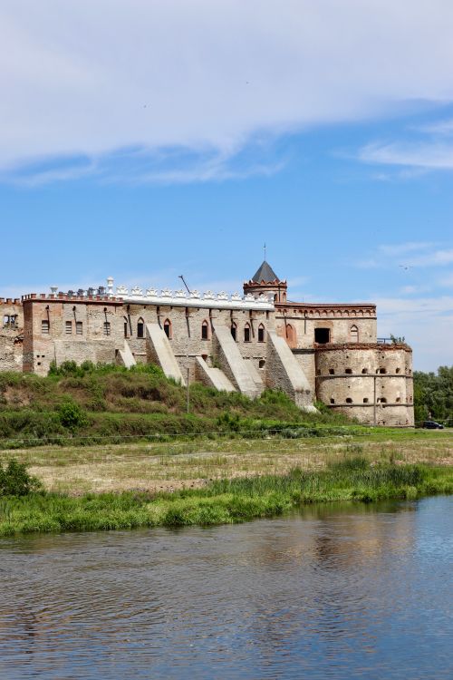 Free Historic Medzhybizh Castle in Ukraine by a serene river on a summer day. Stock Photo