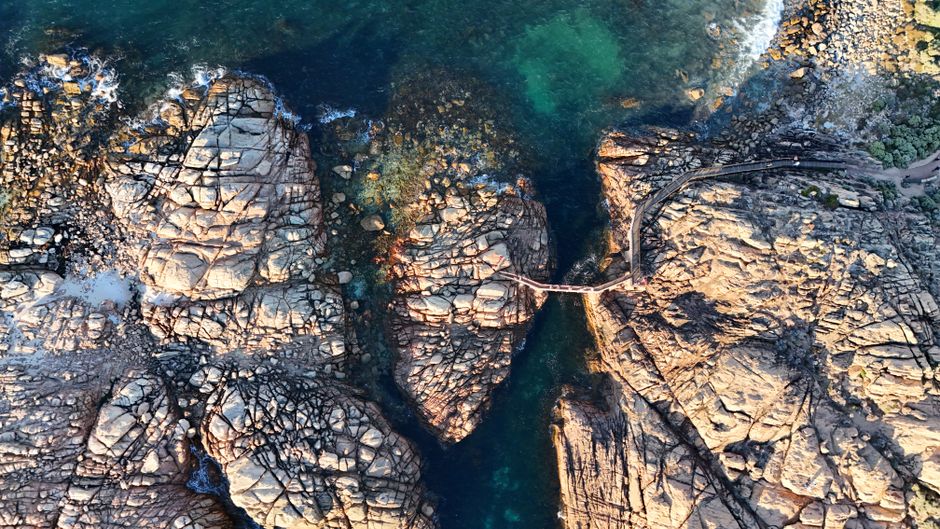 Sydney Grand Tour by Helicopter - Stunning aerial shot of Canal Rocks' rugged landscape in Perth, WA, Australia.