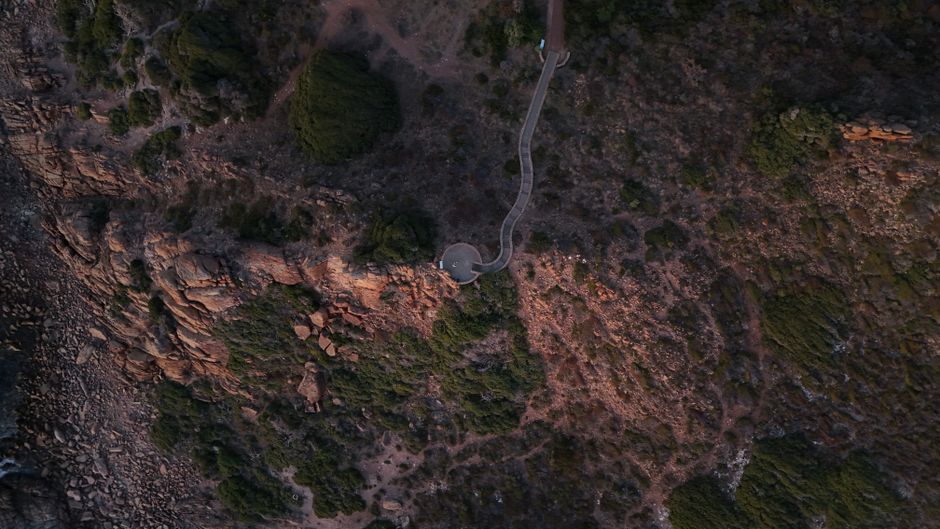 Hunter Valley Wine Country Helicopter Flight from Cessnock - Drone shot of rocky coastal terrain with lush greenery in Western Australia.