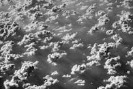 从高空俯瞰，云层呈现单色调，阳光与阴影交织，充满戏剧性