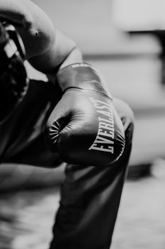 Close-up of a boxer's clenched fist in an Everlast glove. Black and white photography capturing focus and strength in Guatemala City.