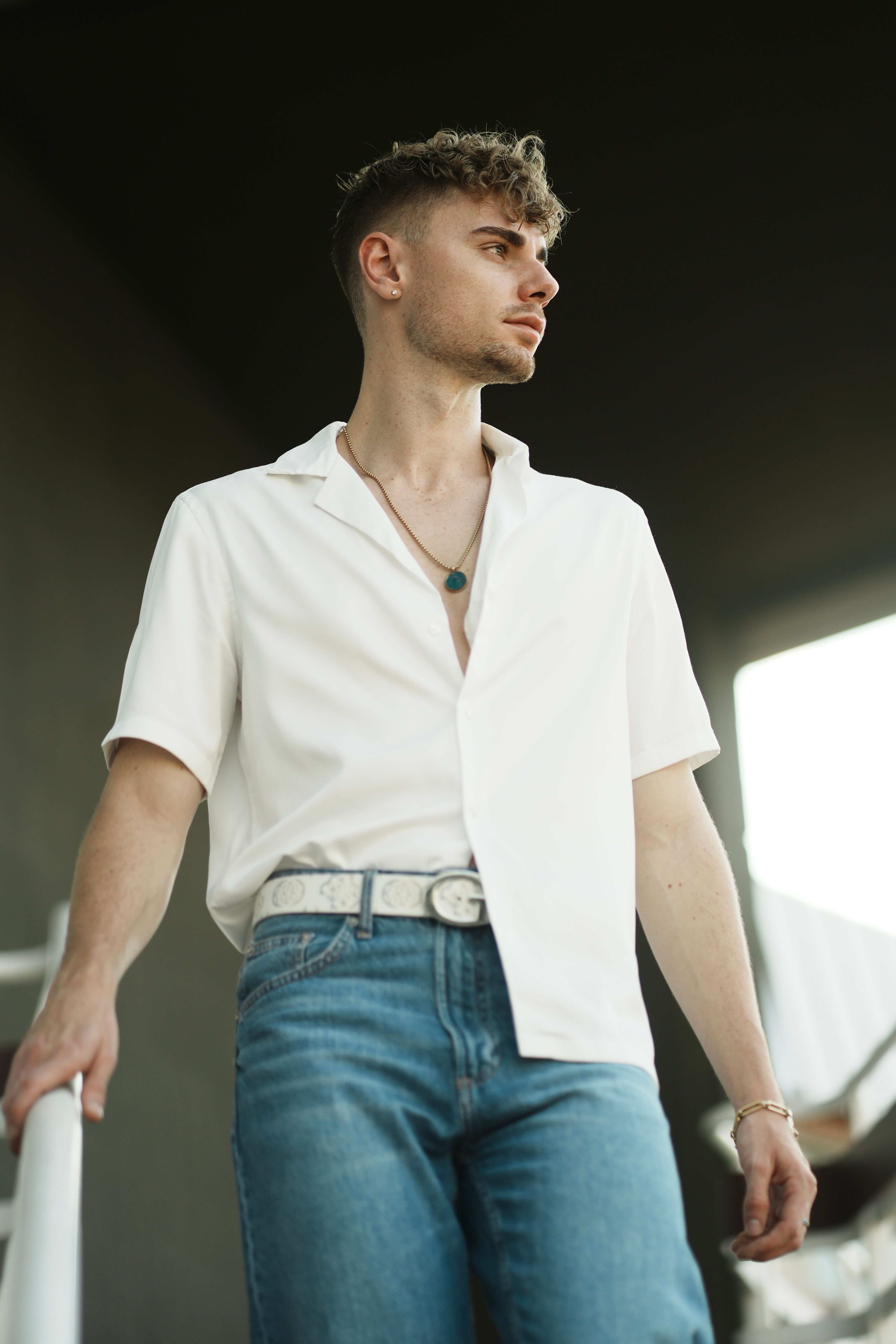 Chic and modern portrait of a young man in casual wear with a confident look.
