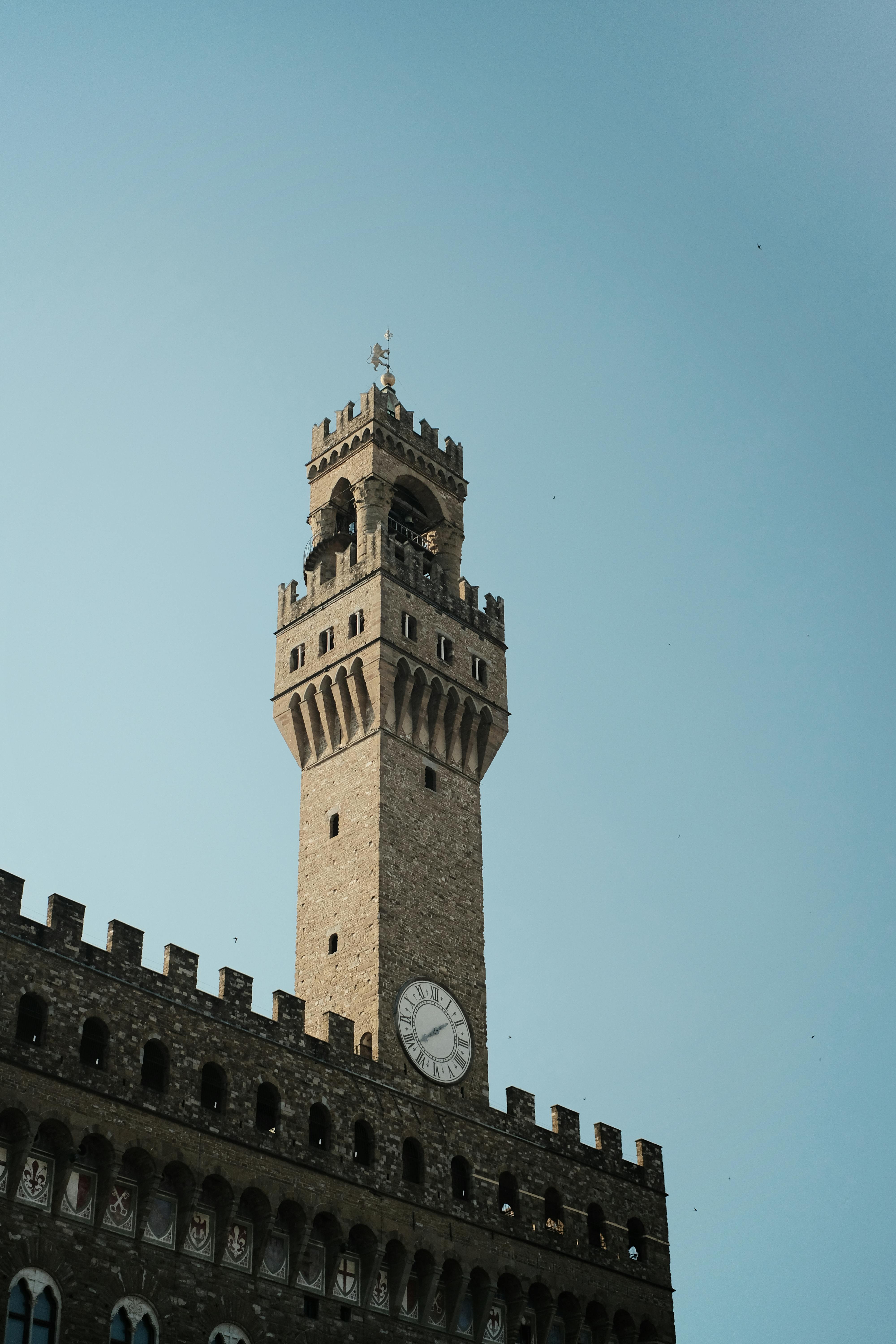 Explore the architectural beauty of Palazzo Vecchio's iconic tower in Florence, Italy.