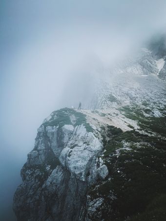 Rock buttress in drifting fog, photo by Andreas Schnabl on Pexels