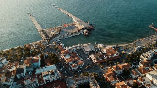 Free Stunning aerial view of Kuşadası harbor, Türkiye during the golden hour with vibrant waterfront and cityscape. Stock Photo