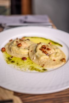 Delicious homemade ravioli served with herb-infused olive oil and crispy toppings.
