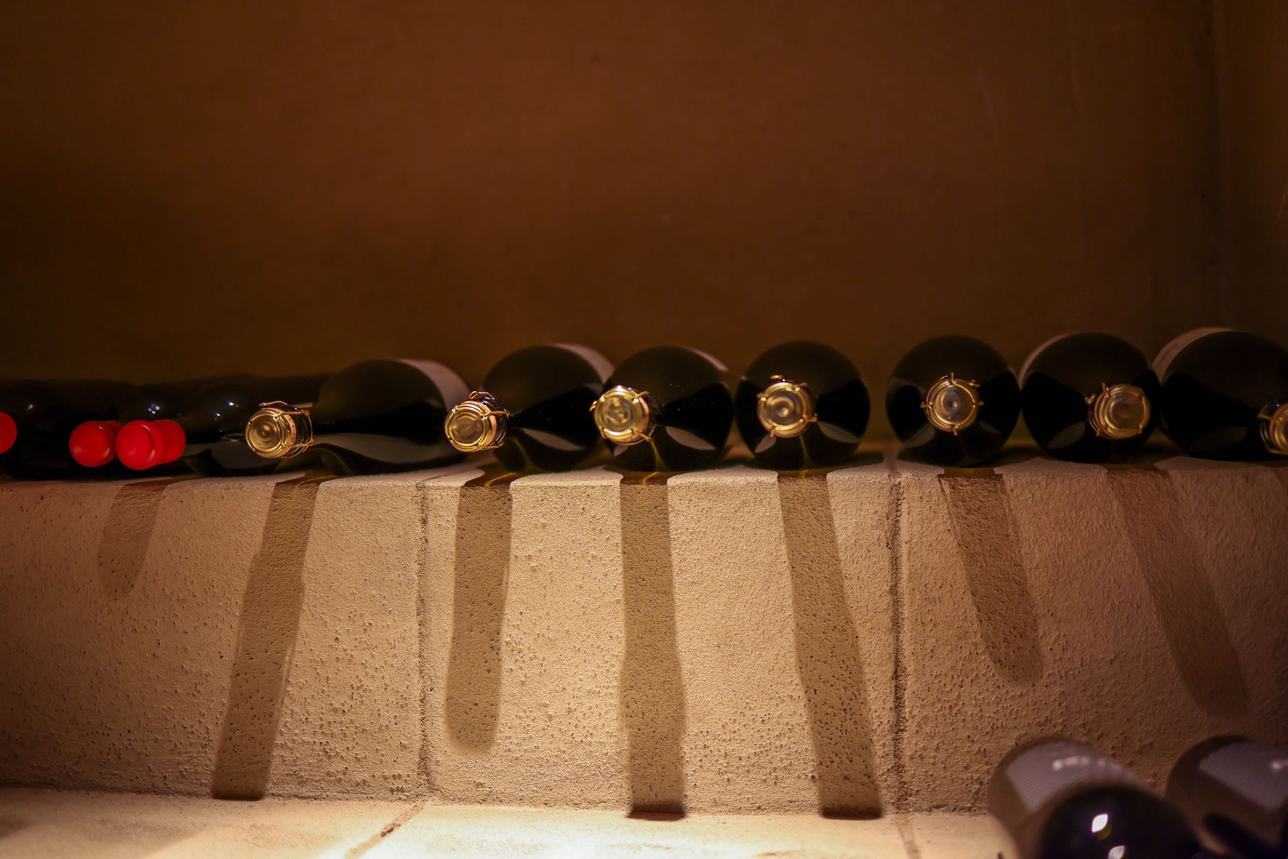 Wine cellar with bottles arranged in a dimly lit restaurant setting