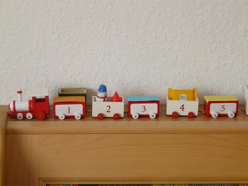 Plastic Toy Train on Wooden Rack