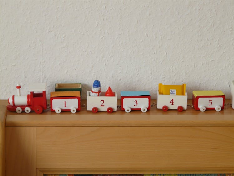 Plastic Toy Train On Wooden Rack