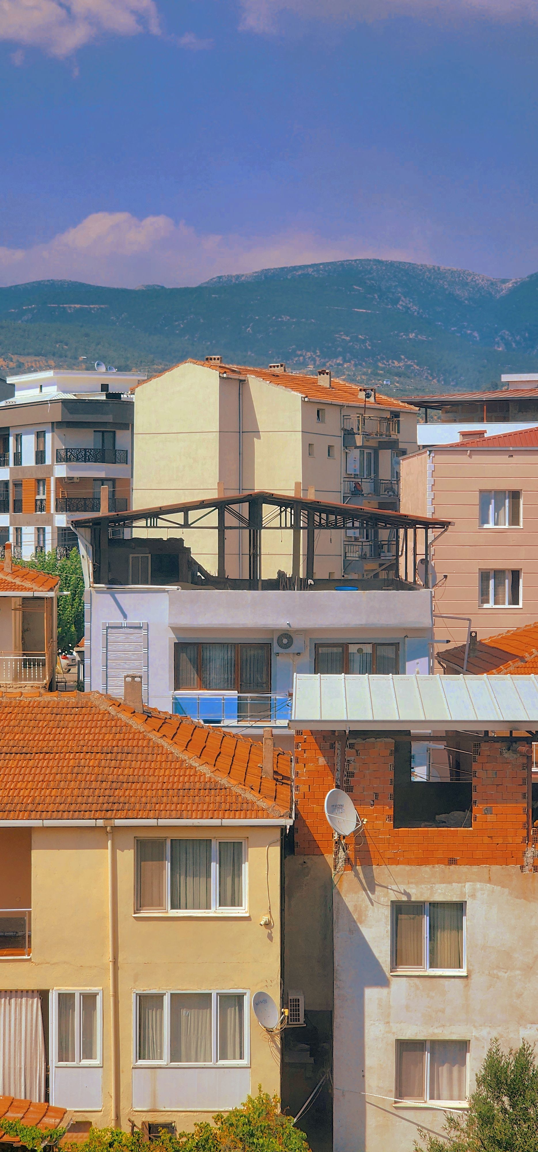 A vibrant urban skyline showcasing diverse residential architecture under a clear sky.