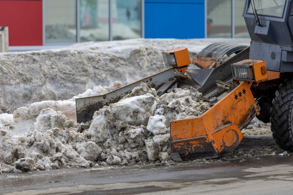 A commercial snow plow clearing a large parking lot during a heavy Stoneham snowstorm - snow plowing Stoneham MA A commercial snow plow clearing a large parking lot during a heavy Stoneham snowstorm - snow plowing Stoneham MA