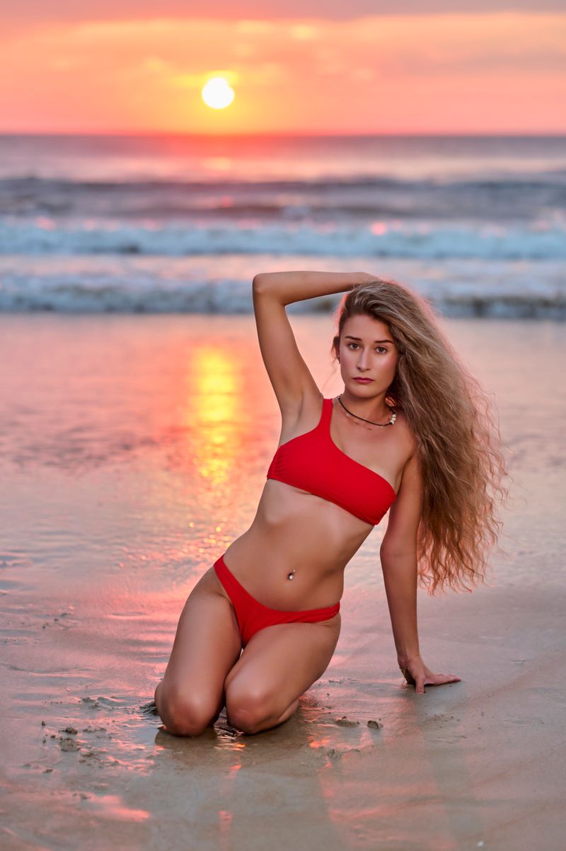 A Woman in a Red Bikini Posing on the Beach · Free Stock Photo