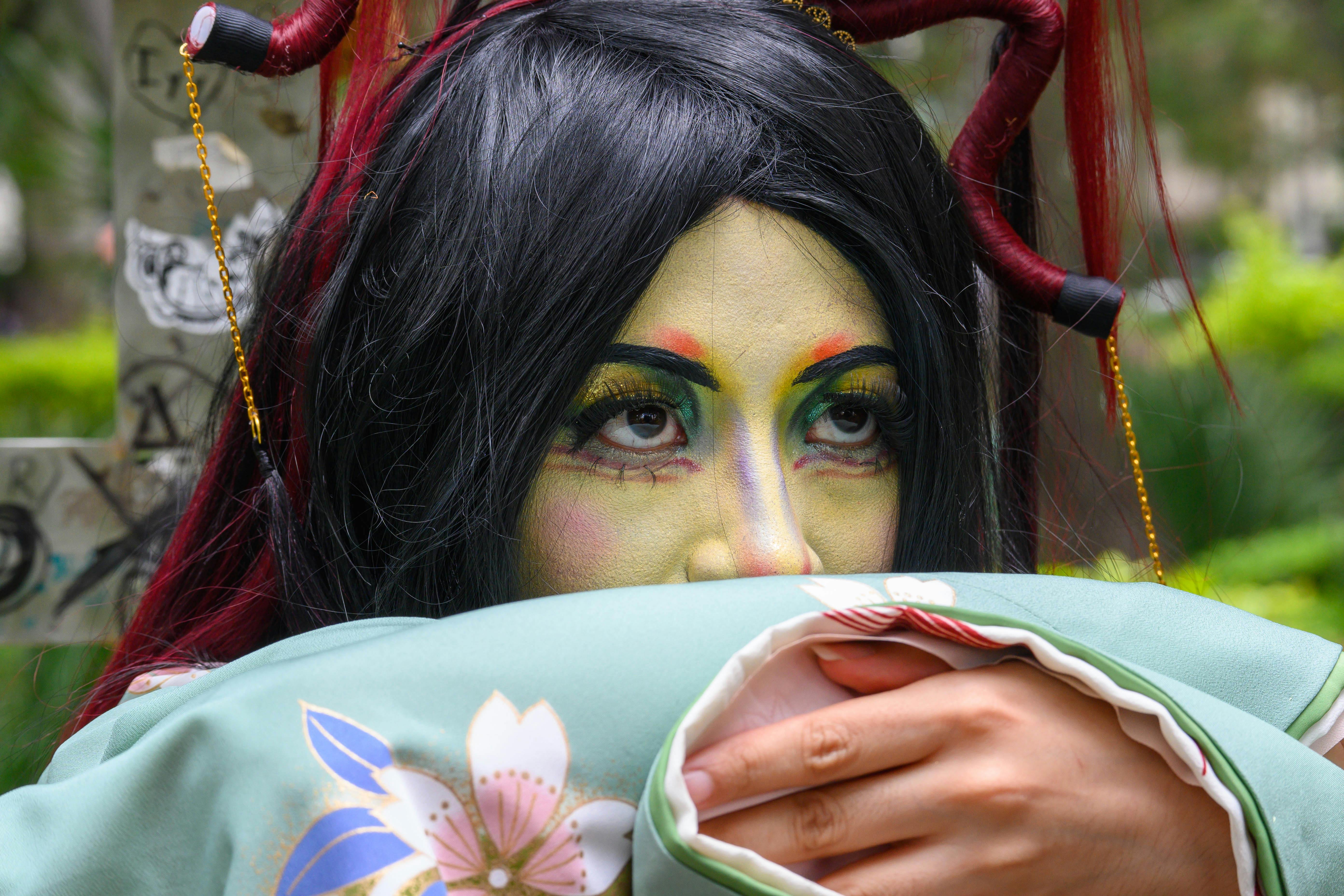 a woman with a face painted with black and red