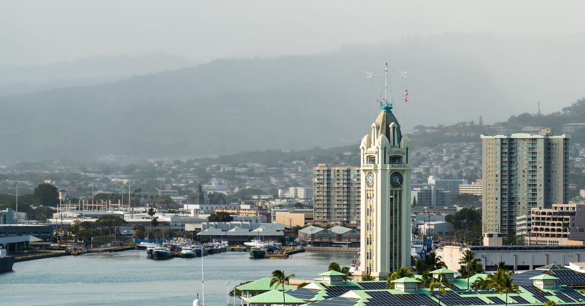 Photo by Donovan Kelly Aerial view of Aloha Tower and the waterfront in Honolulu, showcasing the skyline and harbor.