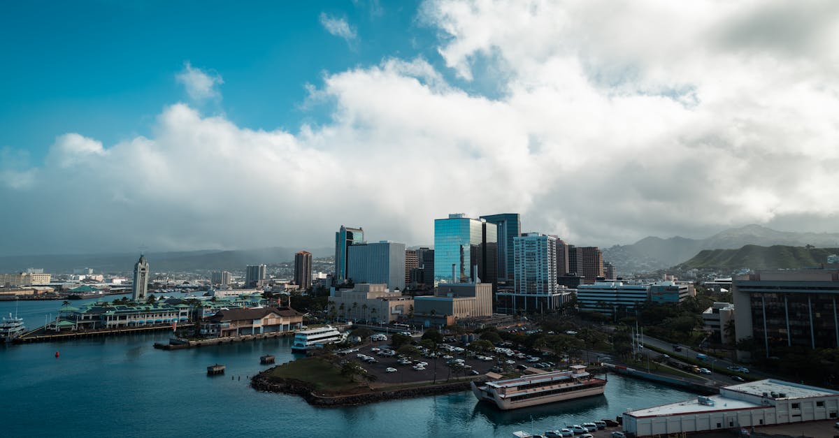 A stunning view of Honolulu's harbor with skyscrapers and mountains in the backdrop.