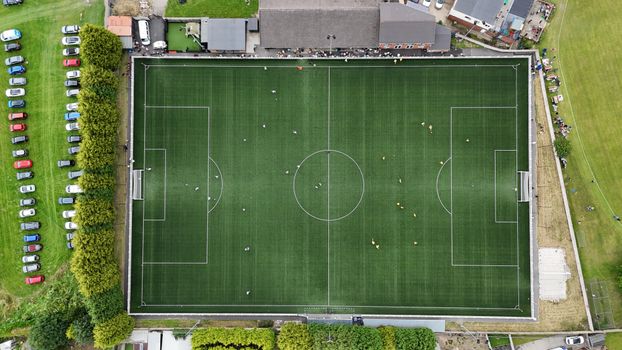 Aerial shot capturing a soccer match at a green football field in Fitzwilliam.