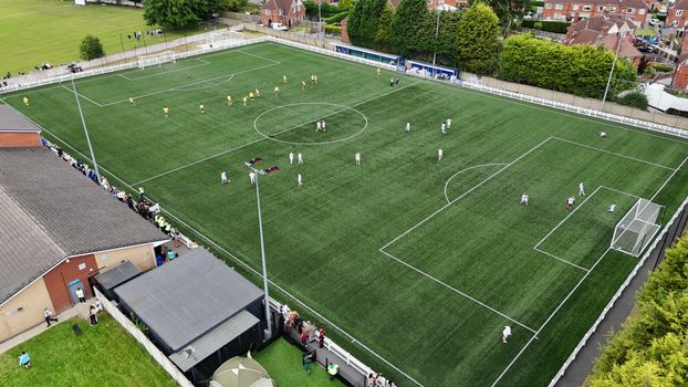 Aerial photo of a soccer match in Fitzwilliam, England showing active players and spectators.