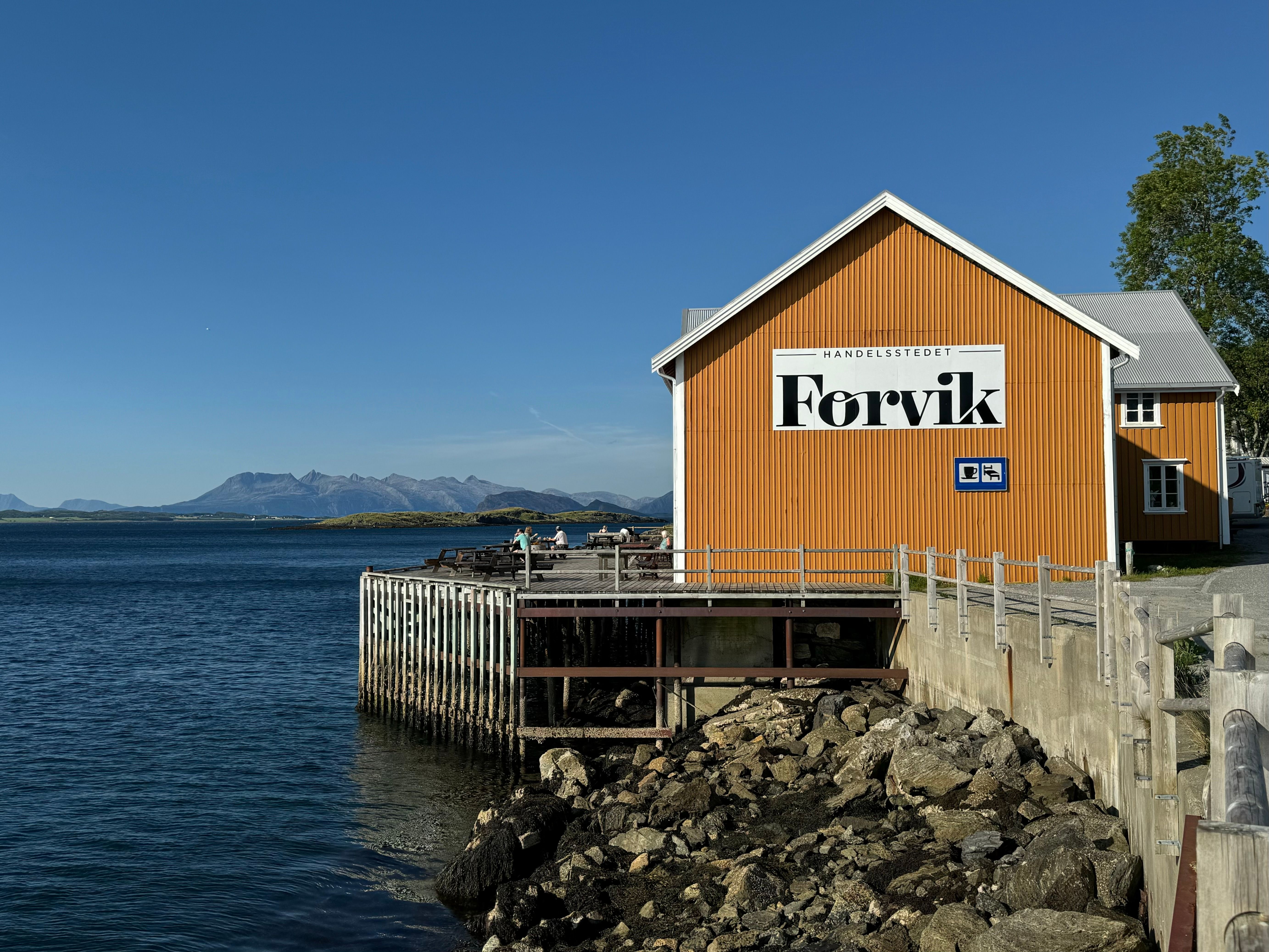 Lakeshore Hotel with Mountains in the Background · Free Stock Photo