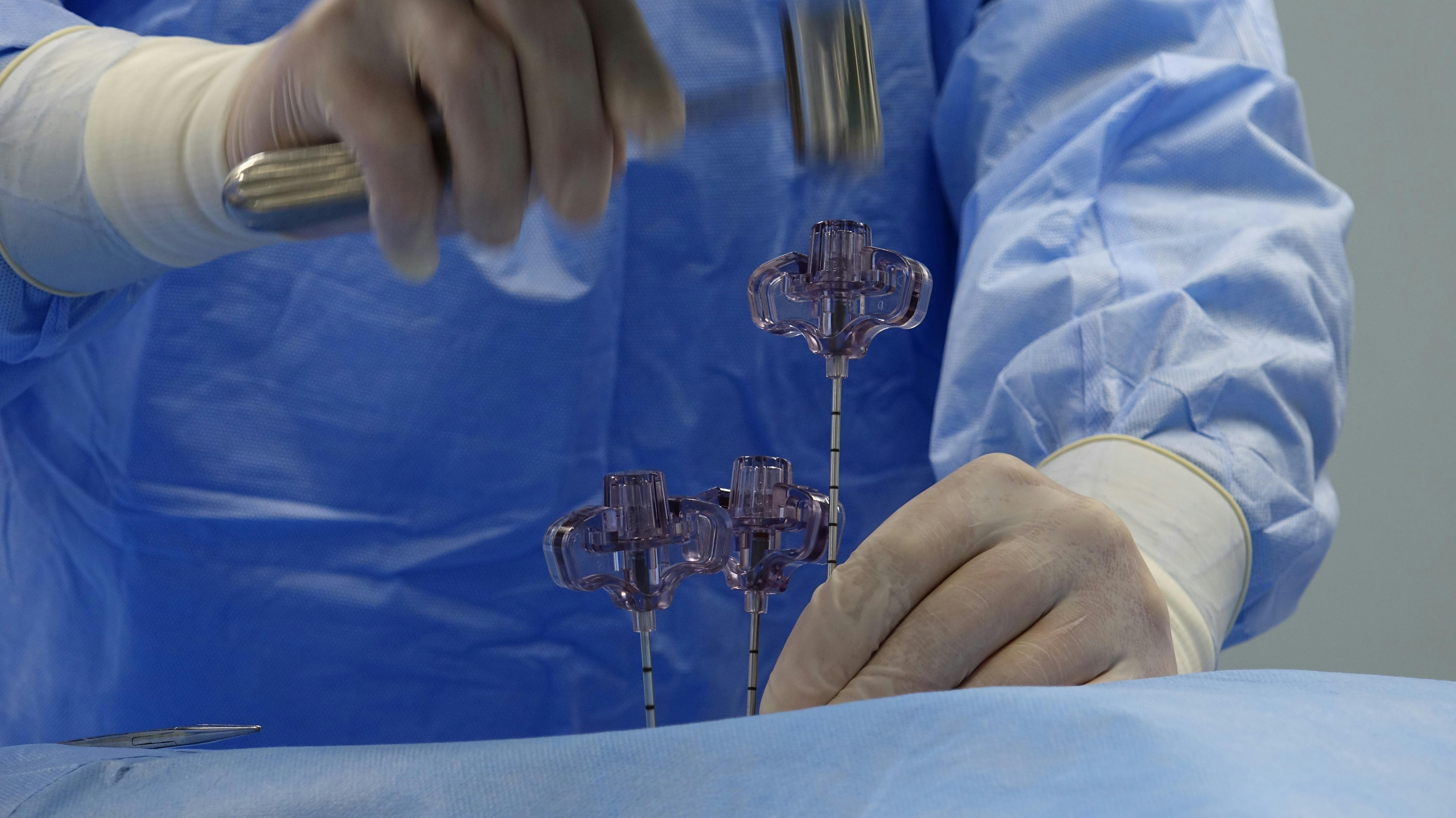 a surgeon is working on a needle in a surgical room