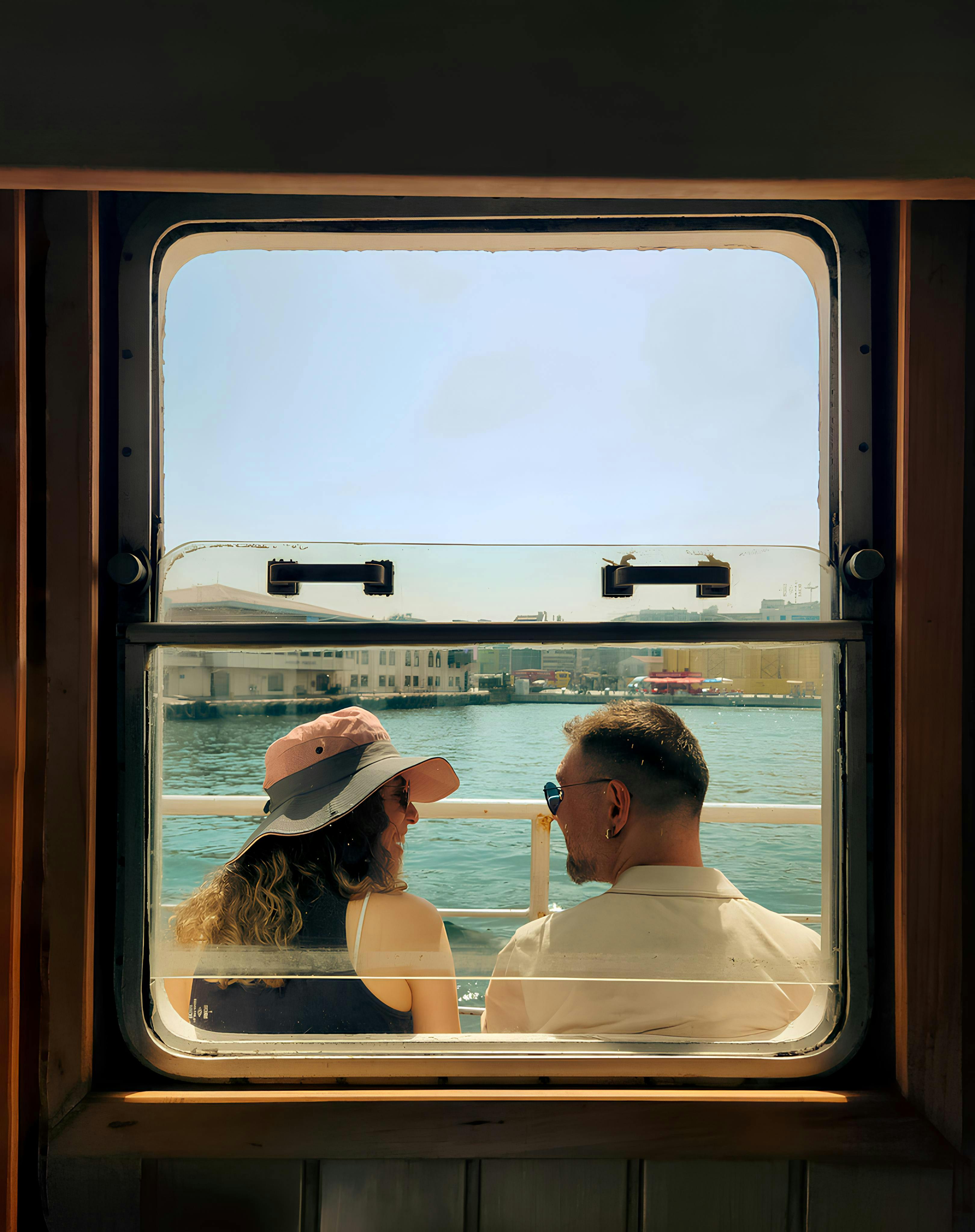 a couple looking out the window of a boat