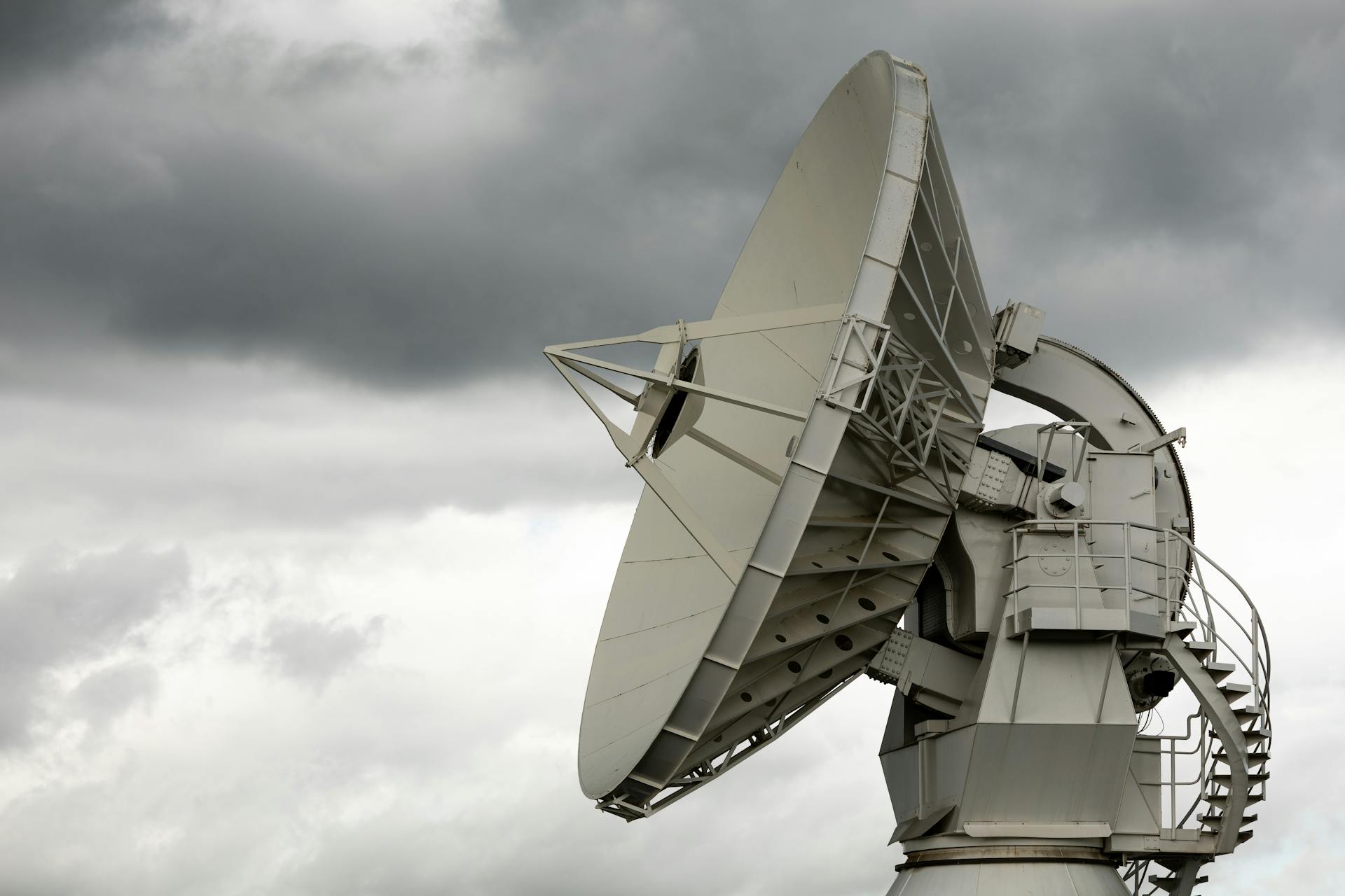 A large satellite dish on top of a building